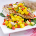 Colourful mango salsa tops seared chicken with tangy lime and savoury garlic