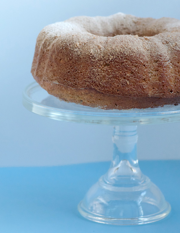 Cake on glass stand, dusted with sugar