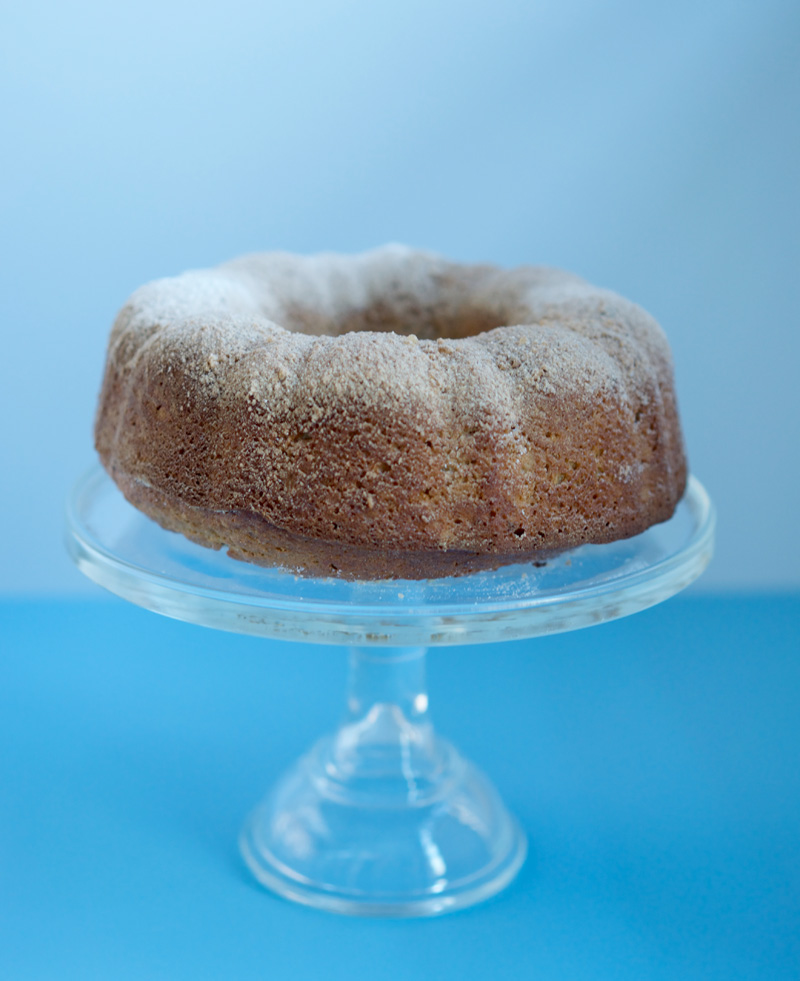 Cake on pretty glass stand with soft blue background