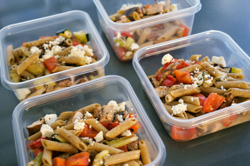 Four lunch containers with pasta and veg ready to go