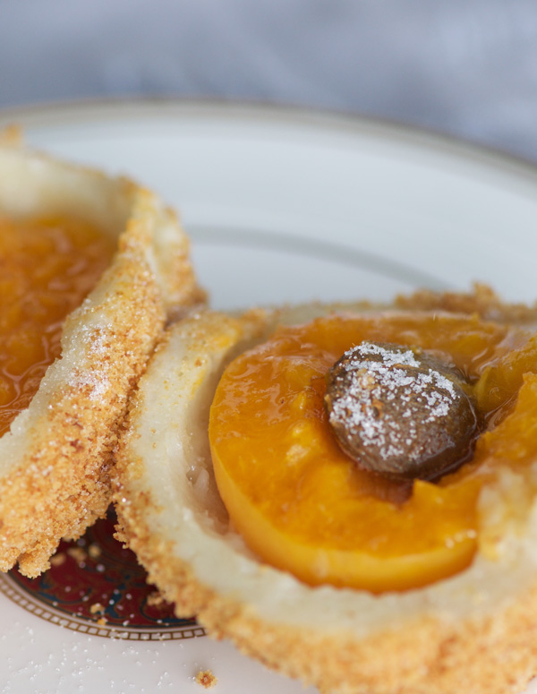Close up shot of juicy apricots inside fluffy potato dumplings