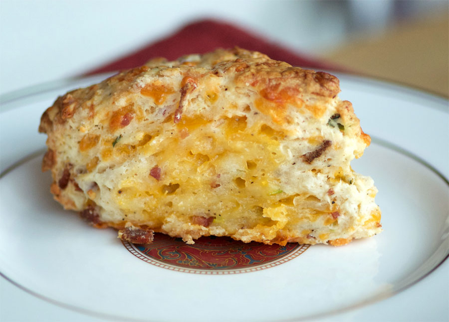 A savoury scone with melted cheese, bacon and green onions