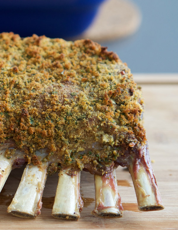 Golden breadcrumbs adorn a roast rack of lamb fresh from the oven