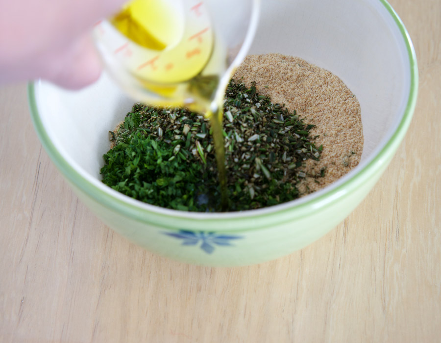 olive oil is mixed into chopped herbs and breadcrumbs