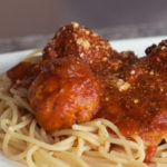 Parmesan Turkey Meatballs piled high onto spaghetti noodles with tomato sauce