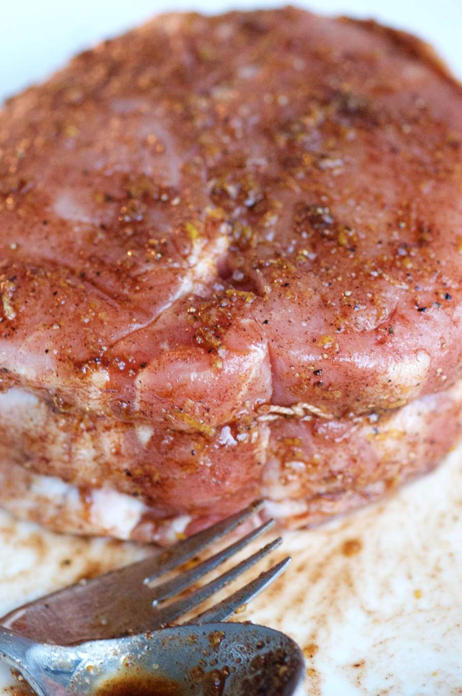 The rub is applied generously to the pork roast