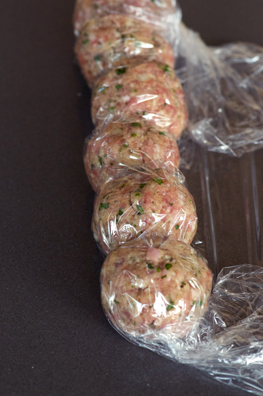 Meatballs getting wrapped for the freezer as part of meal prep