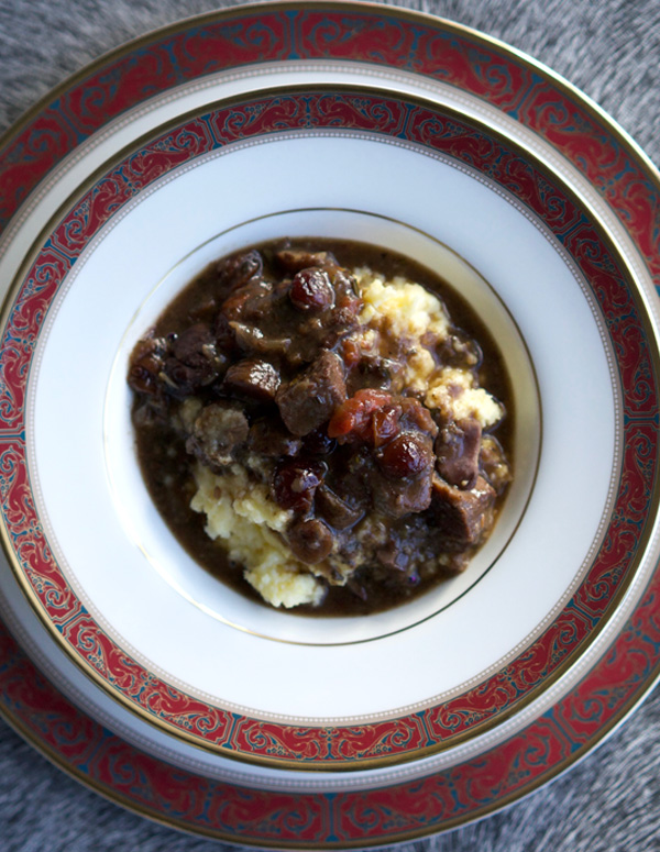 Lamb stew with chestnuts served over creamy polenta