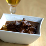 A bowl of beef goulash with rich gravy.